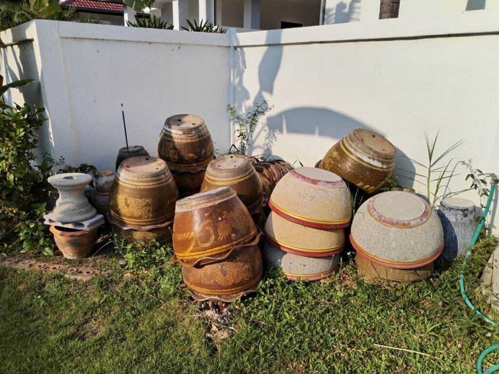 A number of large, upturned, ceramic flowerpots
